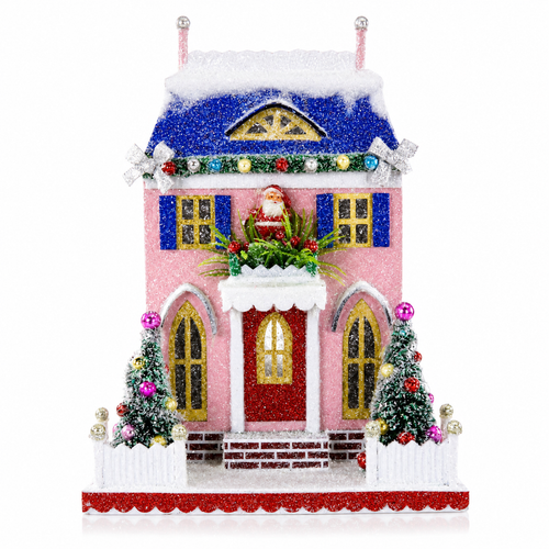 Pink glittered cardboard Santa cottage with blue snowy roof, shutters, and white fence.
Christmas village cottage with Santa above the doorway, decorated trees, and frosted sparkle.
Pastel holiday cottage decoration measuring 8.5 x 6.5 x 11 inches.