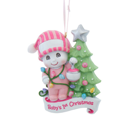 Pink Baby’s 1st Christmas snow kid ornament beside decorated tree.
Personalizable resin ornament with white banner for name or date.
Kurt Adler 3.5 inch pink baby Christmas keepsake ornament.