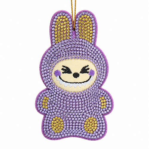 Purple bedazzled monster ornament with sparkling gem-covered body and bunny-style ears.
Embroidered smiling face with black eyes, white teeth, and purple cheeks.
3.5-inch Kurt Adler ornament made from fabric mâché, plastic, and polyester.