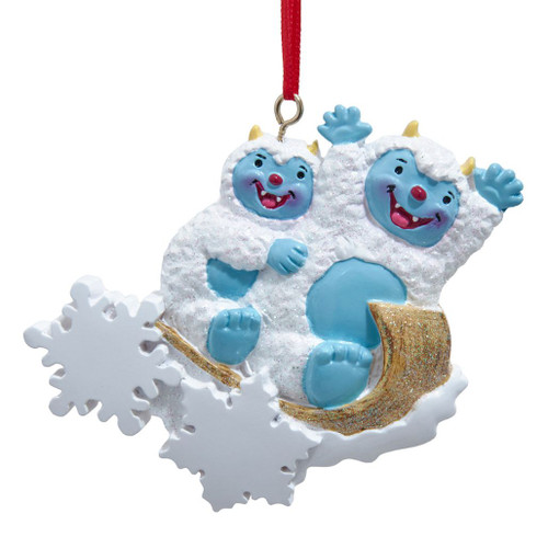 Yeti family of 2 resin ornament with two blue-faced yetis on a glittery sled.
Kurt Adler 4-inch personalized ornament with white snowflakes and red hanging ribbon.
Winter family Christmas ornament featuring two smiling yetis and snow accents.