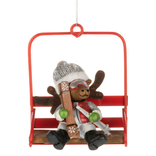 Moose ornament seated on a red ski lift chair holding skis and wearing winter gear.
Polyresin and polyester Christmas ornament featuring a skiing moose with goggles and knit hat.
Mountain-inspired holiday ornament with detailed chair lift and winter sports theme.