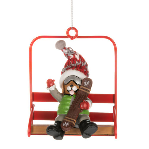 Dog ornament seated on a red chair lift holding a snowboard.
Polyresin and polyester dog Christmas ornament with goggles and winter hat.
Alpine holiday ornament featuring a dog on a bright red ski lift chair.