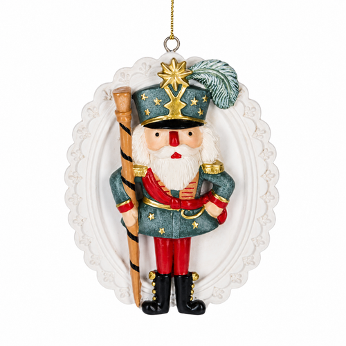 Nutcracker soldier disk ornament with green uniform and red pants.
Resin Christmas ornament with ornate white oval backing and gold accents.
2 5/8 x 3 1/2 inch nutcracker soldier ornament with hanging cord.