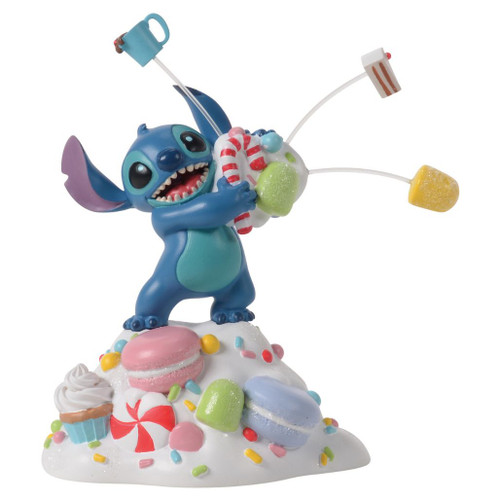 Department 56 Disney Village Stitch accessory holding oversized sweets on a sprinkle-covered base.
Stitch Orders It All figurine with candy canes, cocoa, macarons, and frosted dessert details.
Disney Village Stitch dessert accessory shown from multiple angles with colorful candy accents.