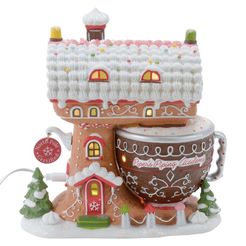 Department 56 Piper’s Piping Academy gingerbread-style North Pole Village building with glowing windows.
Lighted porcelain village building shaped with a mixing bowl, piped icing roof, candy accents, and USB cord.
Piper’s Piping Academy building paired with Piping The Tree accessory, sold separately.