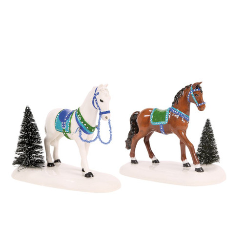 Department 56 Holiday Trotters set with white and brown decorated horses beside snowy sisal trees.
Cross Village horse accessories with blue and green tack on ceramic snow bases.
Set of 2 village horses made from plastic, sisal, and ceramic, each measuring 4.13 inches high.