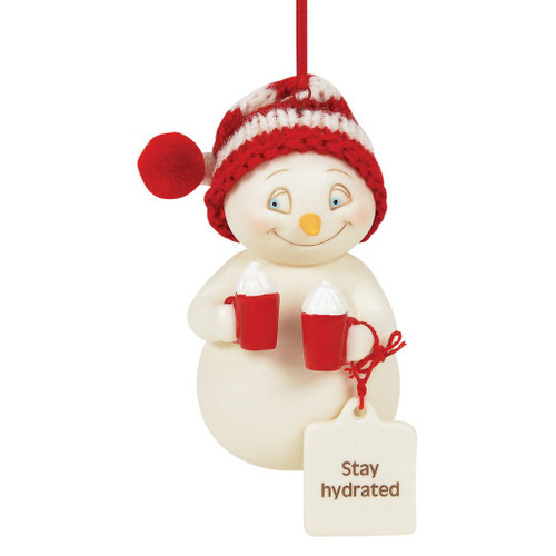 Snowpinions snowman ornament wearing a red-and-white knit hat and holding two festive mugs with a "Stay Hydrated" sentiment tag.
Creamy bisque porcelain ornament with hand-painted details from the 2026 Snowpinions collection.
Front, side, and back views of a whimsical hanging Christmas ornament featuring winter beverage-themed details.