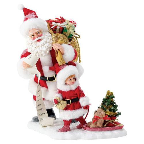 Department 56 Possible Dreams Teddy Takes a Ride figurine with Santa, child, sled, teddy bear, and small tree.
Santa collectible carrying a gold gift sack beside a bundled child pulling a red sled on a snowy base.
Possible Dreams Teddy Takes a Ride figurine measuring 10.5 inches high with PVC, polyresin, polyester, and Clothtique materials.