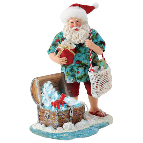 Department 56 Possible Dreams Treasure Chest Santa figurine with Santa, beach base, open chest, shells, and gifts.
Lighted Treasure Chest Santa collectible with glowing white tree, pearls, wrapped presents, and coastal details.
Possible Dreams Treasure Chest Santa figurine measuring 10.5 inches high with LED lighting and battery box.