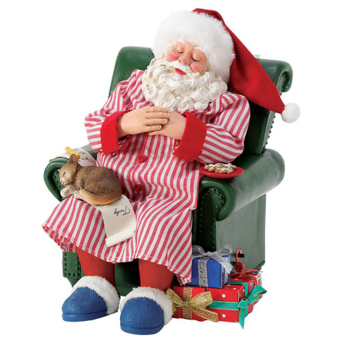 Department 56 Possible Dreams Cat Nap Santa figurine with Santa sleeping in a green armchair.
Santa in a striped nightshirt with a sleepy cat on his lap, cookies, gifts, and a Christmas list.
Cat Nap Santa collectible measuring 9 inches high with battery-operated moving tummy feature.