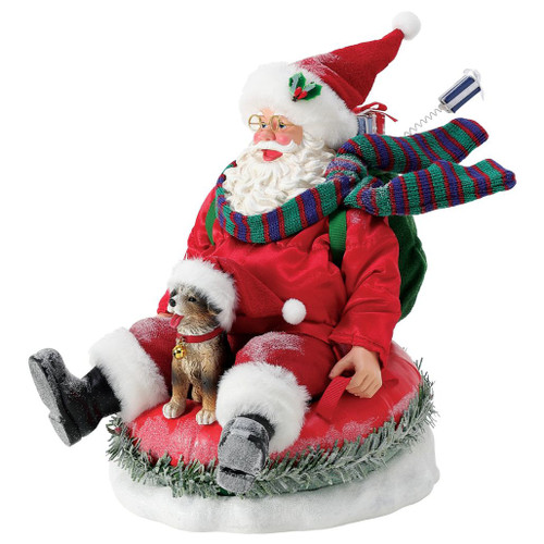 Department 56 Possible Dreams Snow Much Fun Santa figurine on a red snow tube.
Santa rides with Jingle, a striped scarf, green gift sack, and frosted snowy base.
Snow Much Fun Santa collectible measures 9 inches high with Clothtique details.
