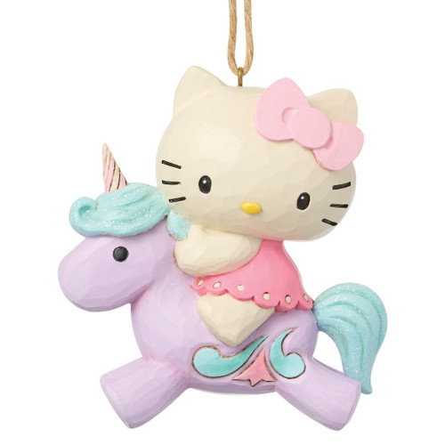 Jim Shore Hello Kitty Unicorn Ornament featuring Hello Kitty riding a pastel purple unicorn with glittered blue mane and tail.

Hand-painted stone resin Hello Kitty Christmas ornament with whimsical unicorn design and attached hanging cord.

3.66-inch Sanrio holiday ornament showcasing Jim Shore's signature folk art styling.