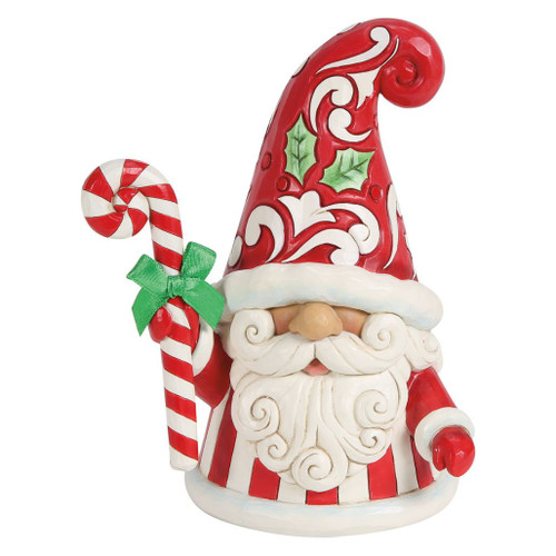 Jim Shore Swirls and Twirls gnome figurine holding a large striped candy cane with a green bow.

Hand-painted stone resin Heartwood Creek collectible featuring a red folk-art hat with holly accents and a striped coat.

Christmas gnome figurine measuring approximately 6.69 inches tall.