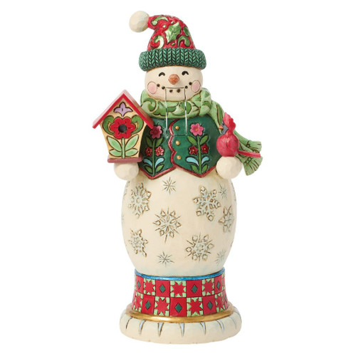 Jim Shore snowman nutcracker holding a colorful birdhouse and red cardinal with a movable mouth lever.
Hand-painted stone resin snowman figurine wearing a green scarf, knit hat, and folk-art floral vest.
Heartwood Creek decorative Christmas snowman nutcracker with embossed snowflakes and winter detailing.
