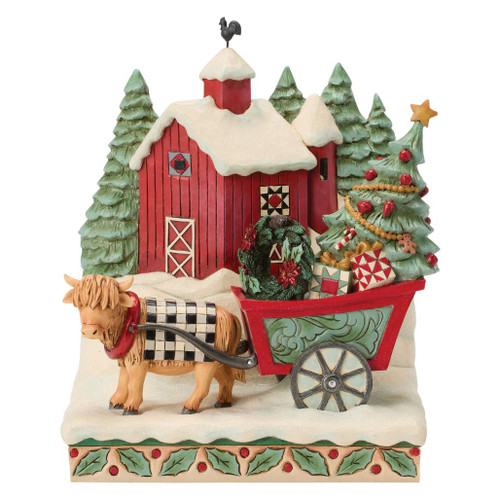 Jim Shore Highland Glen barn scene featuring a Highland cow pulling a festive holiday wagon in the snow.
Hand-painted stone resin Christmas figurine with a red barn, decorated tree, wreath, gifts, and evergreen trees.
Heartwood Creek Highland Glen "Full of Christmas Spirit" holiday collectible with rustic countryside details.