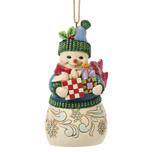 Jim Shore Snowman with Arms Full ornament featuring a smiling snowman carrying wrapped Christmas presents.
Hand-painted Heartwood Creek stone resin ornament with a blue knit hat, holly trim, red scarf, and folk-art details.
4.53-inch hanging Christmas snowman ornament celebrating the joy of holiday gift giving.