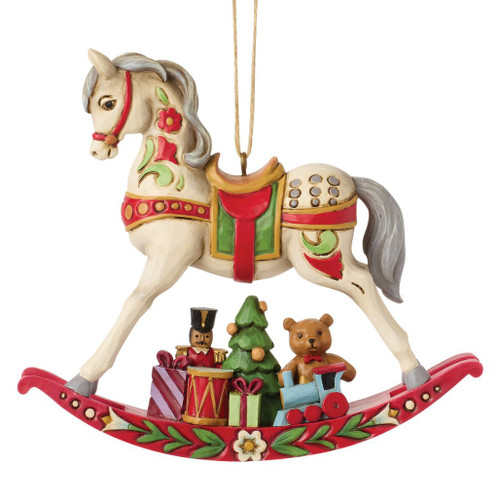 Jim Shore Rocking Horse ornament featuring a hand-painted rocking horse with classic folk-art detailing.
Heartwood Creek stone resin ornament with a toy soldier, teddy bear, train, presents, and Christmas tree beneath the horse.
3.94-inch hanging Christmas ornament inspired by vintage holiday toys and nostalgic décor.