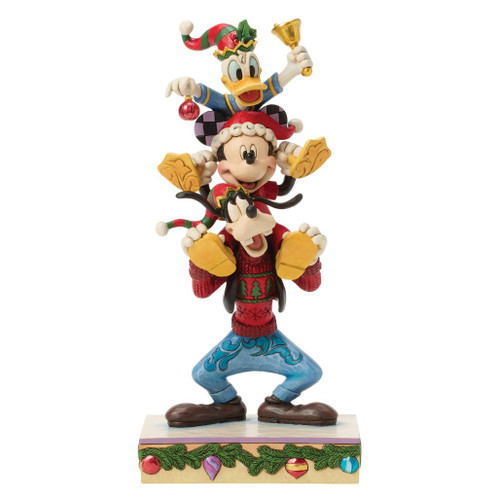 Alt 1: Jim Shore Disney Traditions A Holiday Pile Up figurine featuring Goofy, Mickey Mouse, and Donald Duck stacked in festive Christmas attire.

Alt 2: Hand-painted stone resin Disney Christmas collectible with Goofy carrying Mickey while Donald balances on top holding a bell.

Alt 3: Disney Traditions A Holiday Pile Up figurine showcasing Mickey, Donald, and Goofy with holiday ornaments and Jim Shore folk-art details.