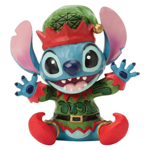 Alt 1: Jim Shore Disney Traditions Stitch Elf Mini figurine wearing a green elf outfit with red shoes and jingle-bell hat.

Alt 2: Hand-painted stone resin Stitch mini collectible dressed as Santa's little helper with festive folk-art detailing.

Alt 3: Disney Traditions Stitch Elf Mini holiday figurine with colorful elf costume and cheerful expression.