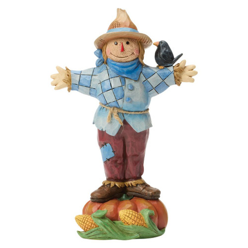 Jim Shore scarecrow standing on a pumpkin with a crow perched on its shoulder.
Hand-painted stone resin Heartwood Creek harvest figurine featuring patchwork clothing, corn, and folk-art detailing.
Autumn scarecrow collectible with straw hat and pumpkin base for seasonal home décor.