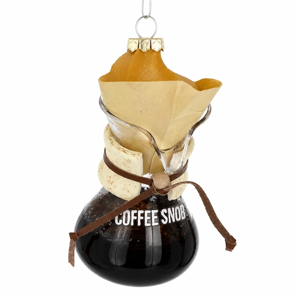 Glass ornament shaped like a pour-over coffee maker with Coffee Snob lettering.
Coffee-themed Christmas ornament with filter, carafe, and dark coffee detail.
Hanging glass coffee ornament measuring 2.25 × 2.25 × 4.5 inches.