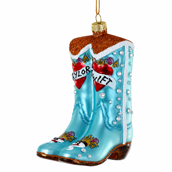 Glass blue cowboy boots ornament with glitter trim and hanging loop.
Music-themed boot ornament with heart details and Taylor Swift banners.
4 inch glass Taylor Swift Boots Christmas ornament on a white background.
