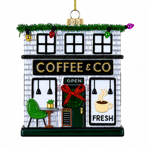Glass coffee shop ornament with storefront, wreath, red bow, and colorful holiday lights.
Hanging café Christmas ornament with “COFFEE & CO” sign and fresh coffee window graphic.
Coffee Shop glass ornament, 3.75 x 1.25 x 4 inches.