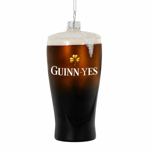 Glass pint ornament with dark stout-style finish and foam top.
Pub-themed ornament with shamrock detail and “Guinn-yes” lettering.
Guinness glass ornament measuring 2 x 2 x 4 inches.