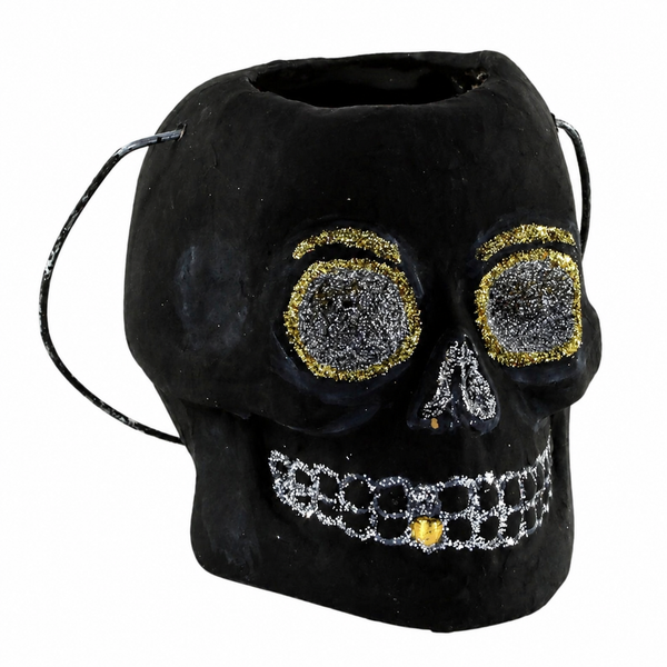 Small black paper mache skull candy bucket with silver and gold glitter accents.
Vintage-style Halloween skull bucket with glittered eyes, nose, teeth, and wire handle.
2.5 x 3 x 3 inch black skull candy bucket for small treats and spooky displays.