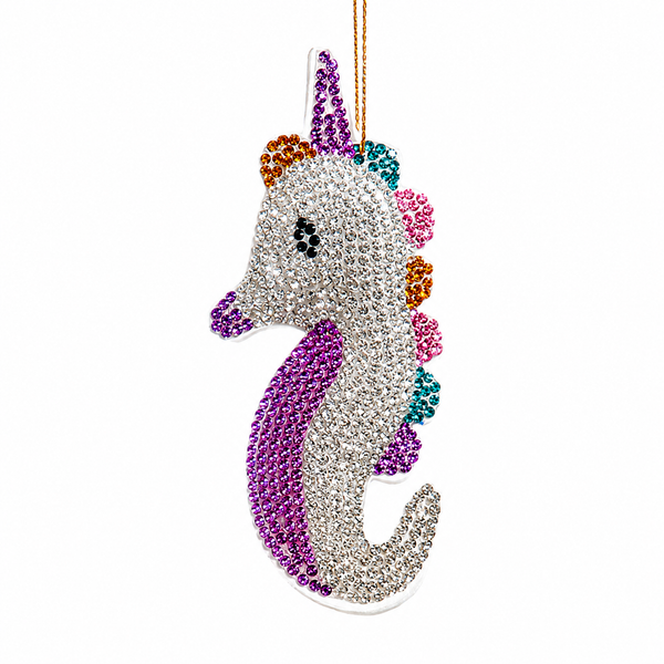 Bedazzled sea horse Christmas ornament with glittering ocean-inspired details.
UV-reactive sea animal ornament made with fabric mâché, plastic, and polyester.
Sparkling sea horse ornament for coastal trees, garlands, wreaths, and nautical décor.