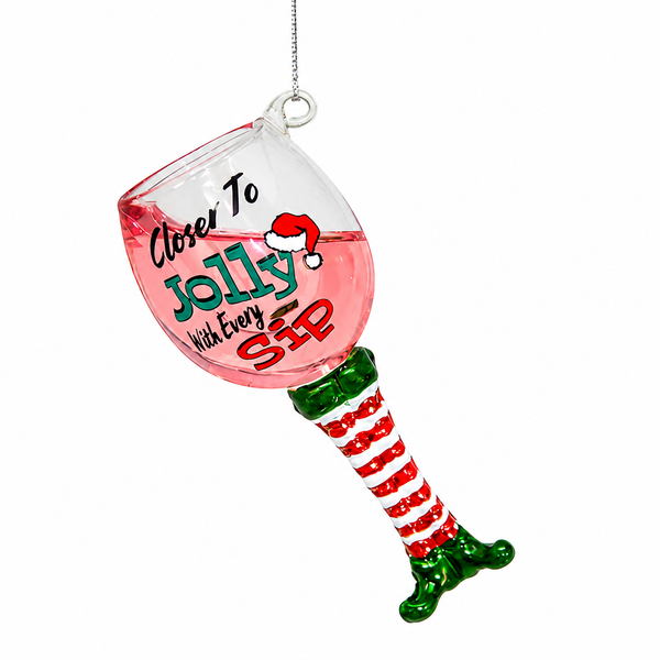 Glass rose wine Christmas ornament with elf-leg stem and Santa hat detail.

Jolly Sip ornament showing pink wine glass, red striped leg, and green elf shoe.

3.8-inch multicolor glass wine ornament with “Closer to Jolly with Every Sip” design.