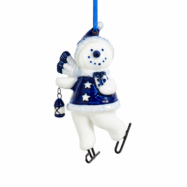 Ice skating snowman ornament carrying a lantern and gift bag.
Porcelain snowman Christmas ornament with blue coat, scarf, and skates.
3.5-inch Kurt Adler hanging ornament with painted mica winter details.