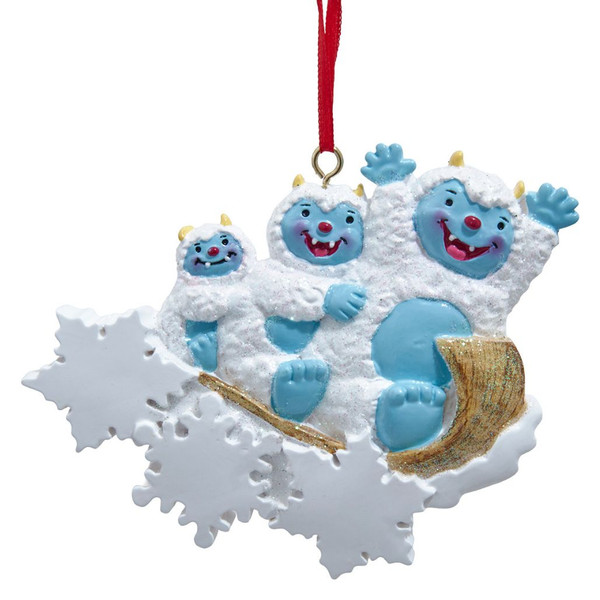Yeti family of 3 resin ornament with three blue-faced yetis on a glittery sled.
Kurt Adler 4.5-inch personalized ornament with white snowflakes and red hanging ribbon.
Winter family Christmas ornament featuring three smiling yetis and snowy accents.