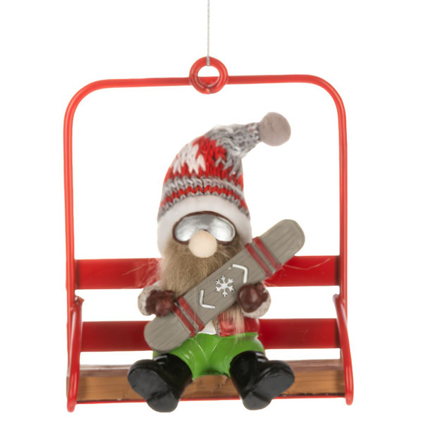Gnome ornament seated on a red chair lift holding a snowboard.
Polyresin and polyester gnome Christmas ornament with goggles and knit hat.
Alpine holiday ornament featuring a gnome on a bright red ski lift chair.