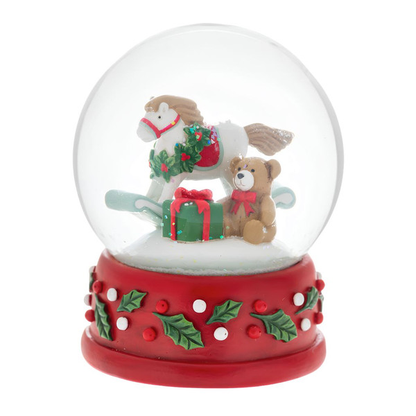 Rocking horse snow globe with teddy bear, gift, and snowy scene inside.
Christmas snow globe with red holly-decorated base and toy accents.
4 x 4 x 5 inch resin, polyresin, and glass rocking horse snow globe.