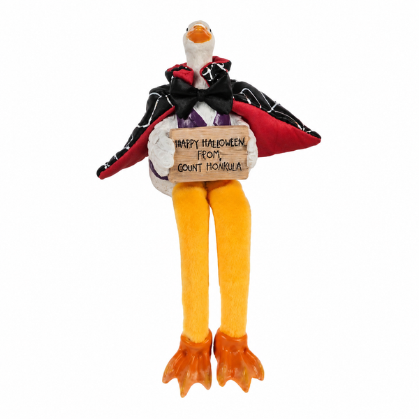 Duck shelfsitter dressed in a vampire cape with bow tie.
Halloween duck figurine holding a Count Honkula sign.
Polyresin vampire duck with dangling orange legs and webbed feet.
