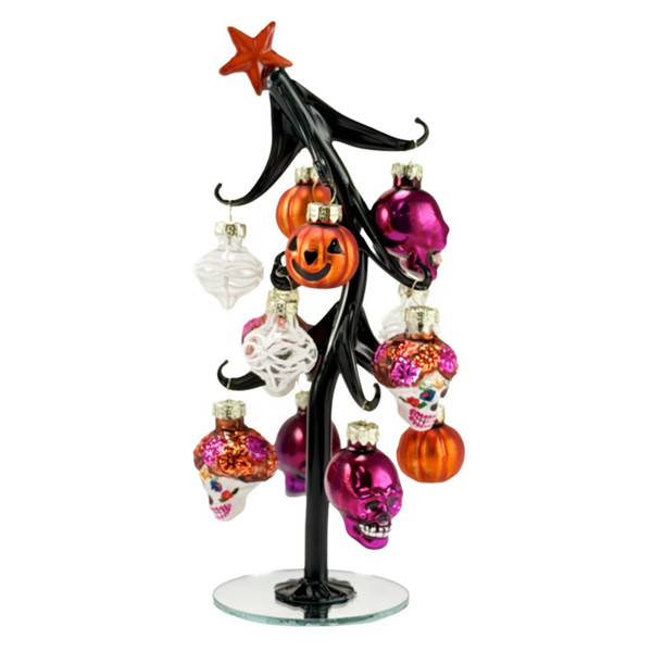Glass slanted Halloween tree with black branches and orange star topper.
Tree displays sugar skull, pumpkin, and white glass ornaments.
8 inch glass tabletop Halloween decoration with 12 hanging ornaments.