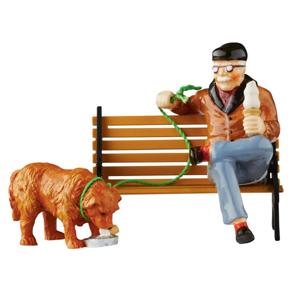 Department 56 Snow Village DQ Treats For Two accessory with man holding a Dairy Queen treat and dog eating from a bowl.
DQ Treats For Two figurine showing man with green leash, golden dog, and ice cream treat accessory.
Display example of DQ Treats For Two with bench shown for staging; bench sold separately.
