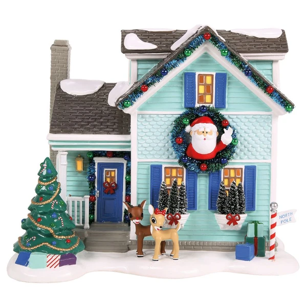 Department 56 Snow Village Rudolph House building with aqua siding, blue shutters, Santa wreath, reindeer figures, and lit windows.
Front view of Rudolph House with decorated tree, snowy roof, garland, North Pole sign, gifts, and USB lighting.
Rear view of Snow Village Rudolph House showing aqua siding, blue door, chimney, USB cord, adapter, and warm windows.