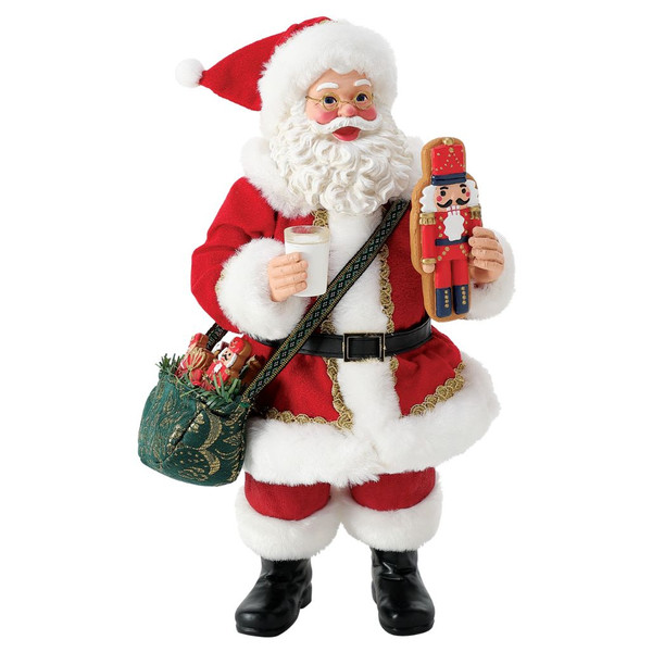 Possible Dreams Nutcracker Sweet Limited Edition Santa figurine holding a nutcracker cookie and a glass of milk.
Department 56 Santa collectible featuring Clothtique fabric clothing, festive shoulder bag, and hand-painted holiday details.
Limited Edition Christmas figurine with Santa carrying seasonal treats and decorative nutcracker-themed accents.