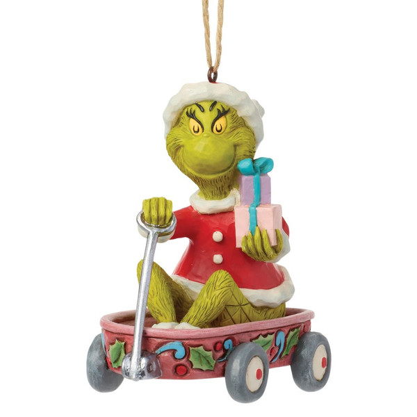 Front view of Jim Shore Grinch in Wagon ornament featuring the Grinch in a Santa suit pulling a festive wagon with wrapped gifts.
Side view showing hand-painted folk-art details, holly decorations, and colorful wagon accents on the stone resin ornament.
Jim Shore Dr. Seuss Grinch Christmas ornament with wagon, gift boxes, hanging cord, and detailed handcrafted finish.