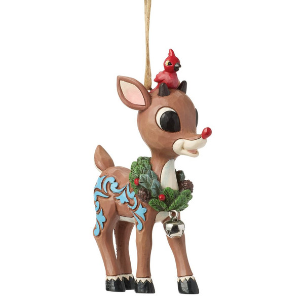 Jim Shore Rudolph with Wreath ornament featuring Rudolph wearing an evergreen wreath with berries, pinecones, and a silver bell.
Hand-painted stone resin Rudolph ornament with a red cardinal perched on his head and blue folk-art rosemaling accents.
Rudolph Traditions by Jim Shore Christmas ornament with hanging cord and festive woodland holiday details.