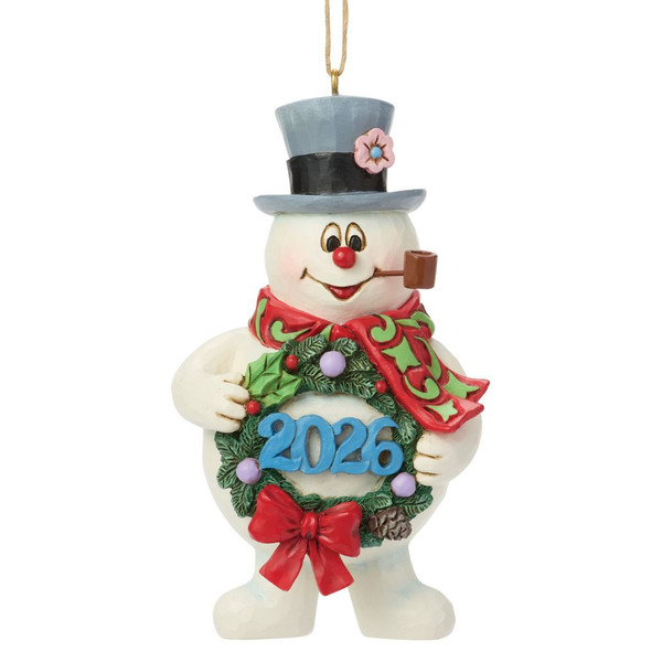 Jim Shore Frosty the Snowman ornament holding a Christmas wreath displaying the year 2026.
Hand-painted stone resin Frosty ornament with festive scarf, top hat, and hanging cord.
Frosty the Snowman 2026 dated Christmas ornament with Jim Shore folk-art styling.