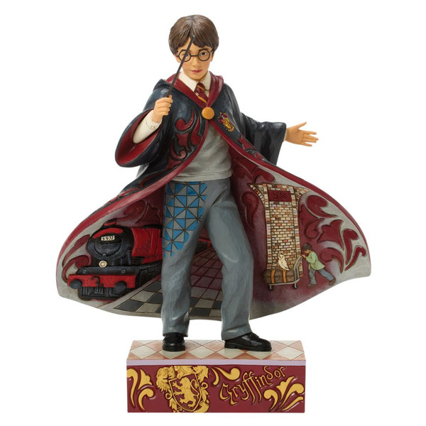 Jim Shore Harry Potter Magical Moment figurine holding a wand with flowing Hogwarts robes.

Hand-painted stone resin Harry Potter collectible featuring Platform 9¾ and the Hogwarts Express inside the cloak.

9.96-inch Harry Potter figurine with folk art patterns and Gryffindor-themed base.