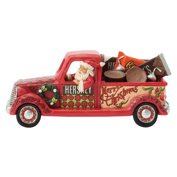 Jim Shore Santa's Candy Cargo figurine featuring Santa driving a vintage red pickup truck filled with Hershey's® and Reese's® candy.

Hand-painted stone resin Christmas figurine with folk-art detailing and festive holiday accents.

Heartwood Creek Santa pickup truck collectible measuring approximately 8 inches long.