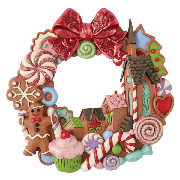 Hand-painted Jim Shore gingerbread Christmas wall wreath with candy, gingerbread houses, peppermint accents, and a metallic red bow.
Side view of the Heartwood Creek Circle in Sweets stone resin wreath showing layered candy details and dimensional design.
Back view of the decorative wreath featuring the integrated keyhole hanger for wall mounting.