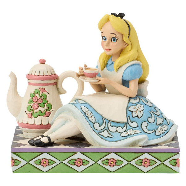 Alt Text 1:
Jim Shore Disney Traditions A Cup of Curiosity figurine featuring Alice seated beside a large floral teapot with a teacup.

Alt Text 2:
Hand-painted stone resin Alice in Wonderland collectible with quilt-inspired folk-art details and pastel colors.

Alt Text 3:
Front view of Jim Shore Alice figurine holding a teacup beside an oversized teapot on a decorative tea party base.