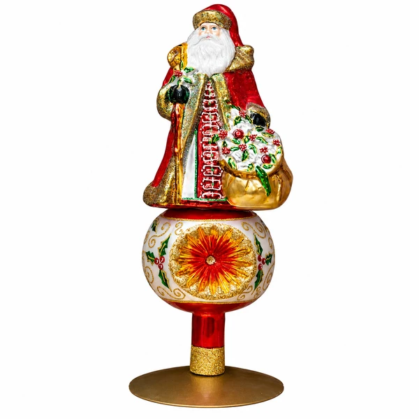 Huras Family Holly Berry Santa handblown glass Christmas tree topper with red, gold, white, and green details.

Hand-painted Polish glass Santa tree topper featuring a holly-covered sack and ornate red-and-gold clothing.

12-inch Santa tree topper with holly berries, reflective ornament-style globe, gold scrollwork, and red-and-gold accents.