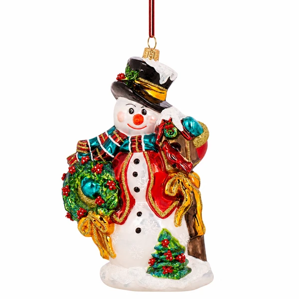 Huras Family Kensington Snowman 6.5-inch handblown glass Christmas ornament.

Snowman glass ornament wearing a red coat, striped scarf, and black holly-trimmed top hat while carrying a green wreath.

Colorful Kensington Snowman ornament with red berry wreath, holiday gift, gold bows, and small decorated Christmas tree.