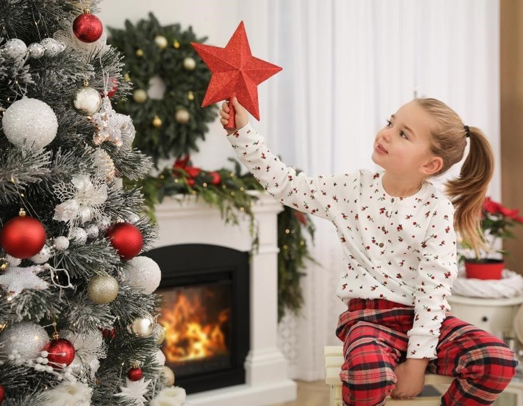 Holiday Tree Toppers Adding Final Touches to Modern Christmas Tree